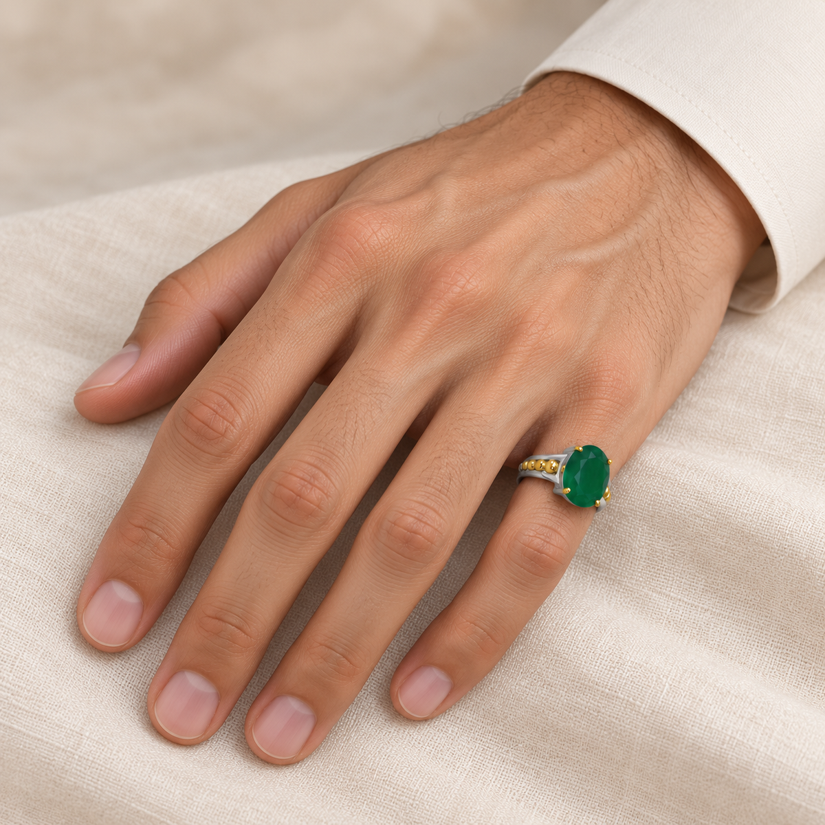 Customer-selected oval green ring on male right little finger