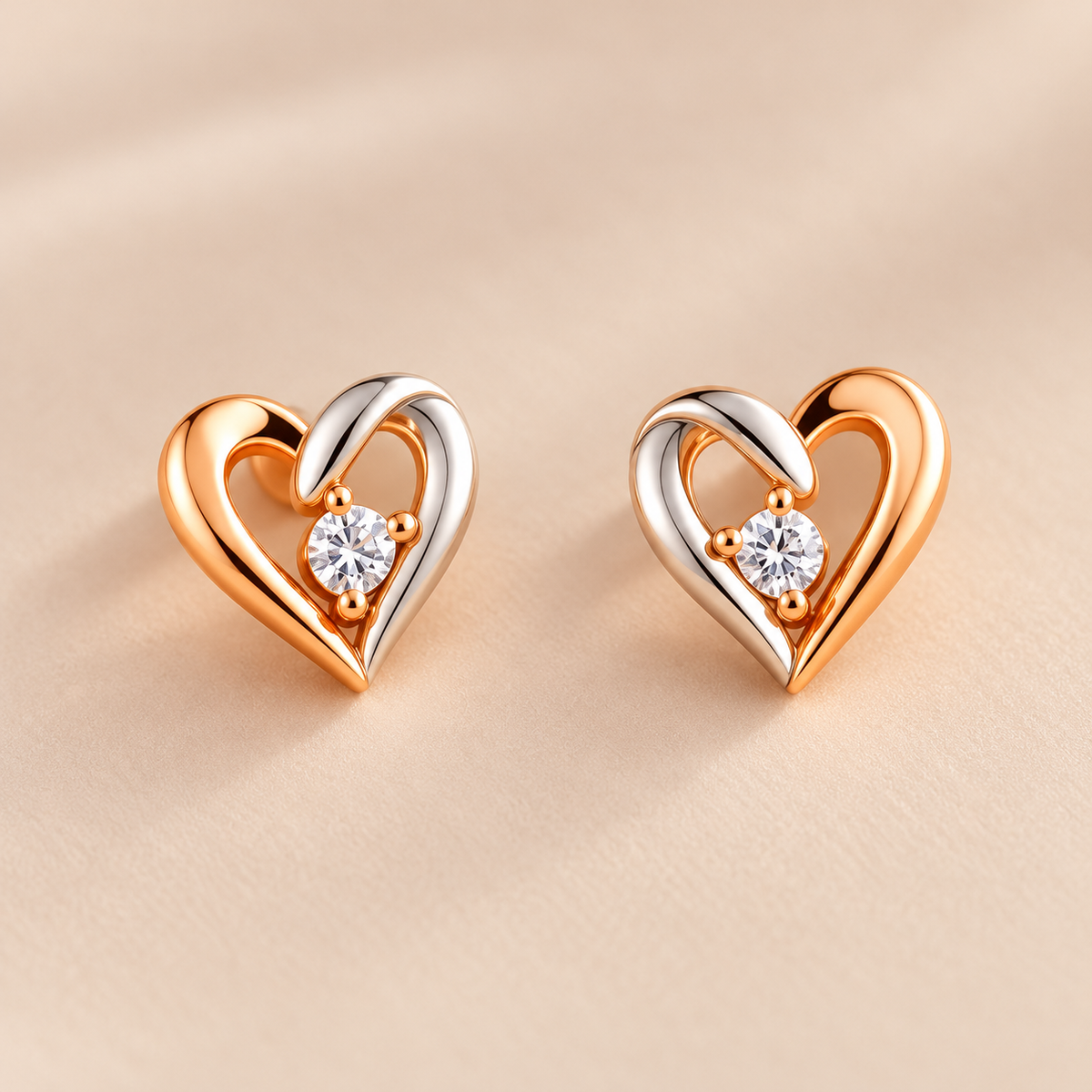 Gold tone heart stud earrings