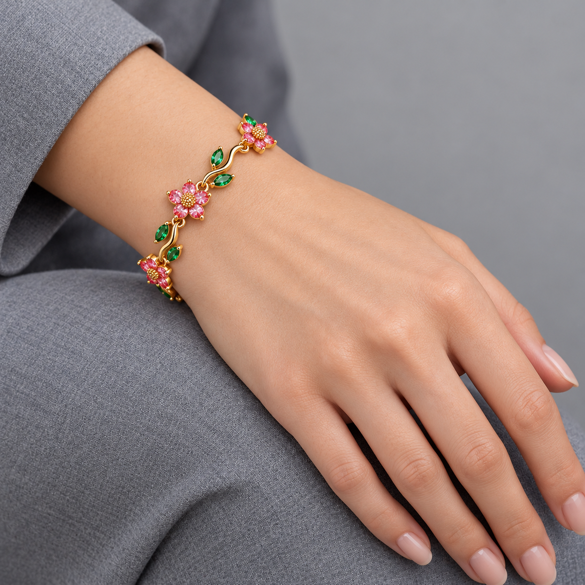 Rosalia Blossom and Vine Bracelet on model hand with grey sleeve