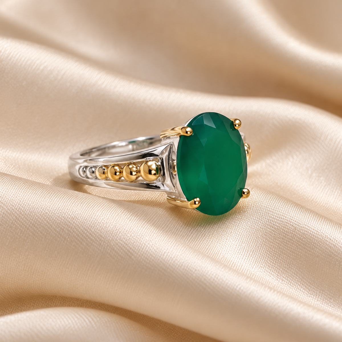 Oval green two-tone men's ring on ivory satin