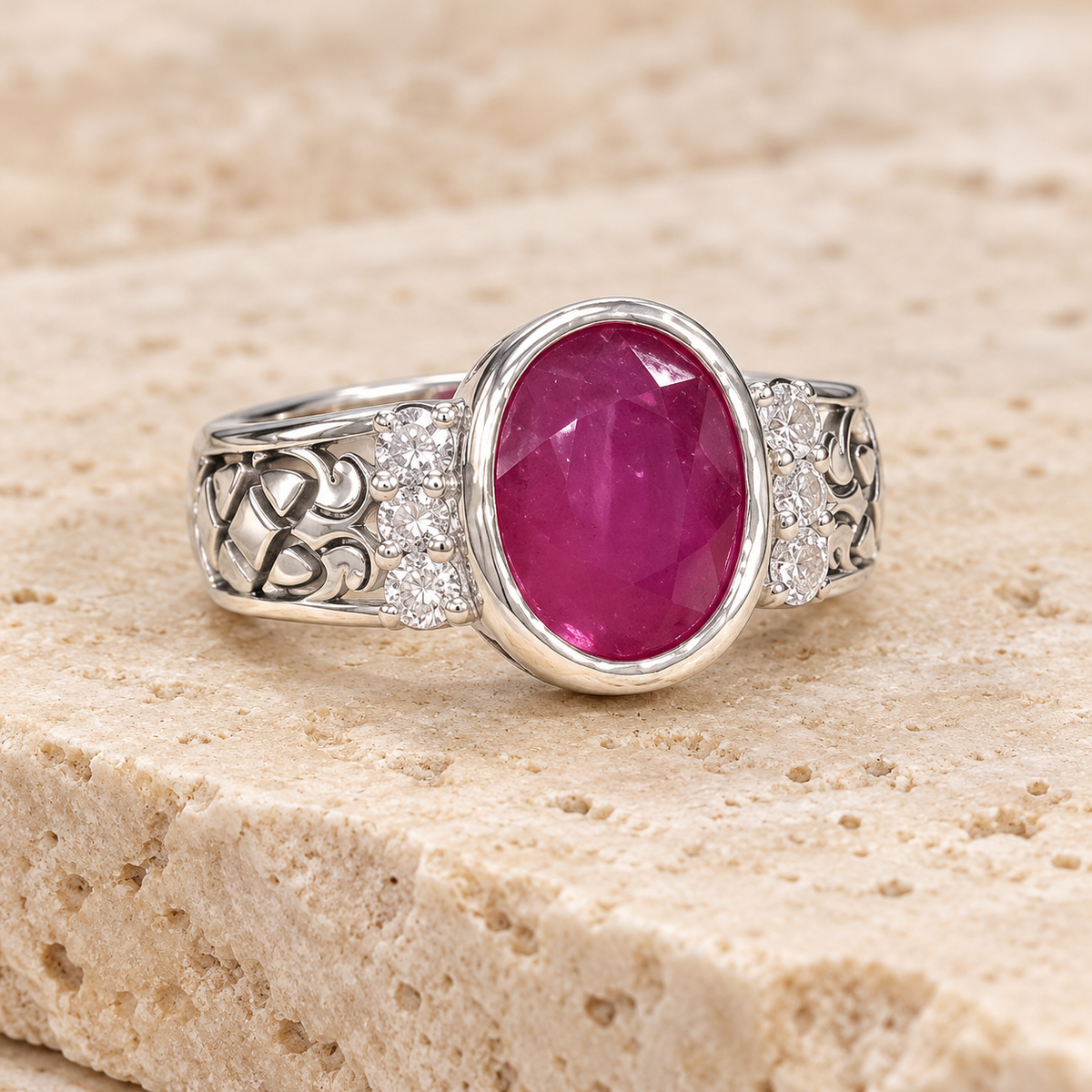 Oval ruby bezel ring with openwork silver shoulders