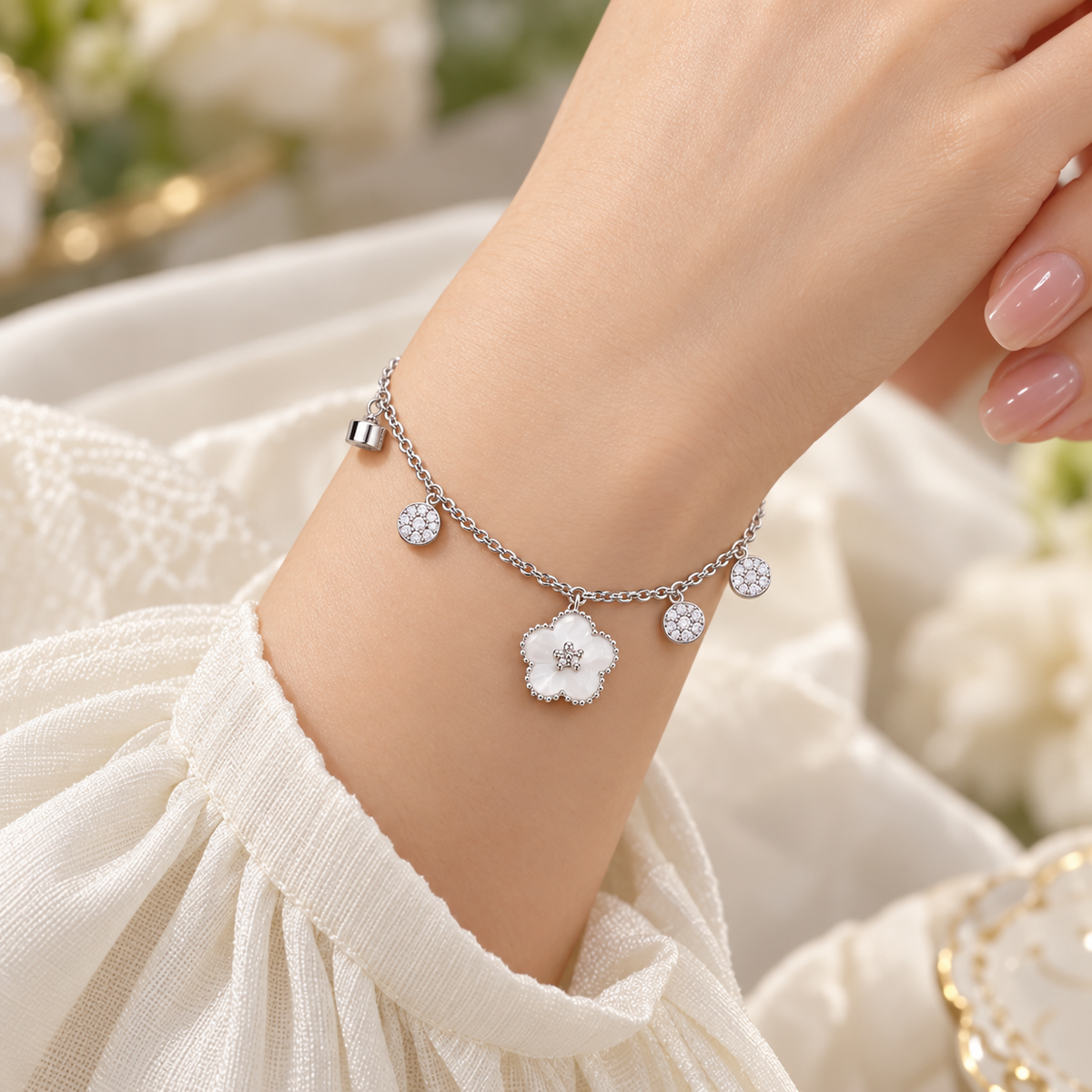 Silver flower charm bracelet on model wrist