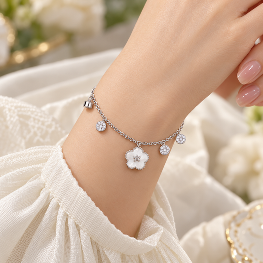 Silver flower charm bracelet on model wrist