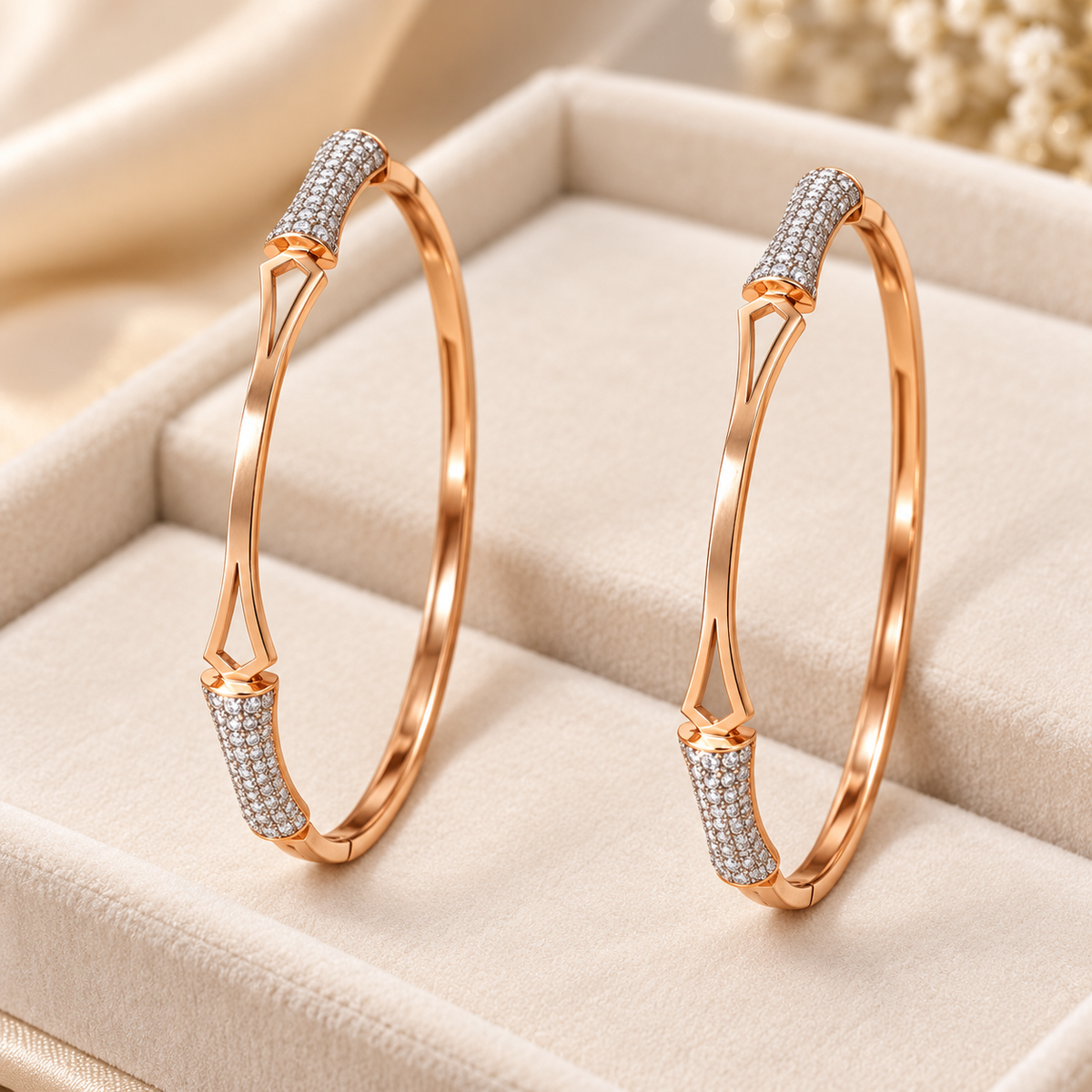 Two gold geometric sparkle bangles on cream velvet