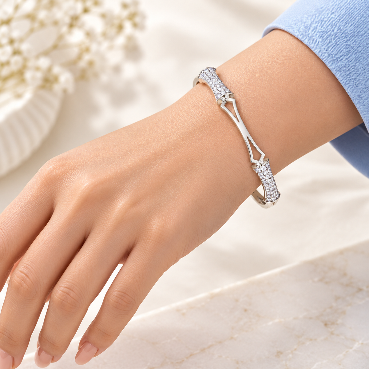 One silver geometric sparkle bangle on model hand