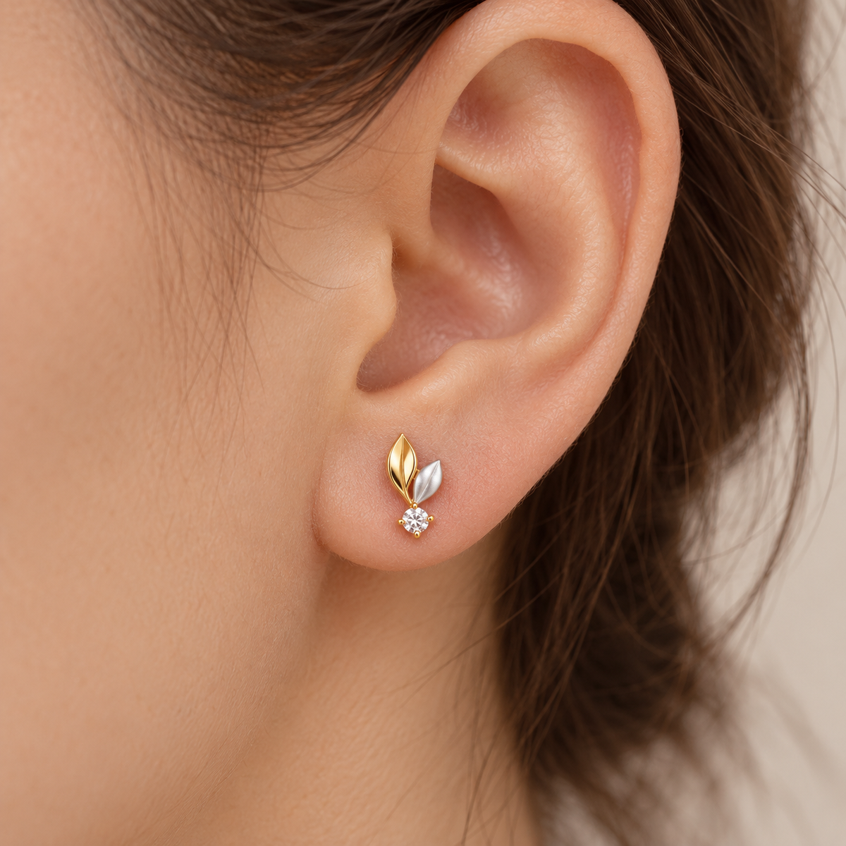 Leaf stud earring on model earlobe