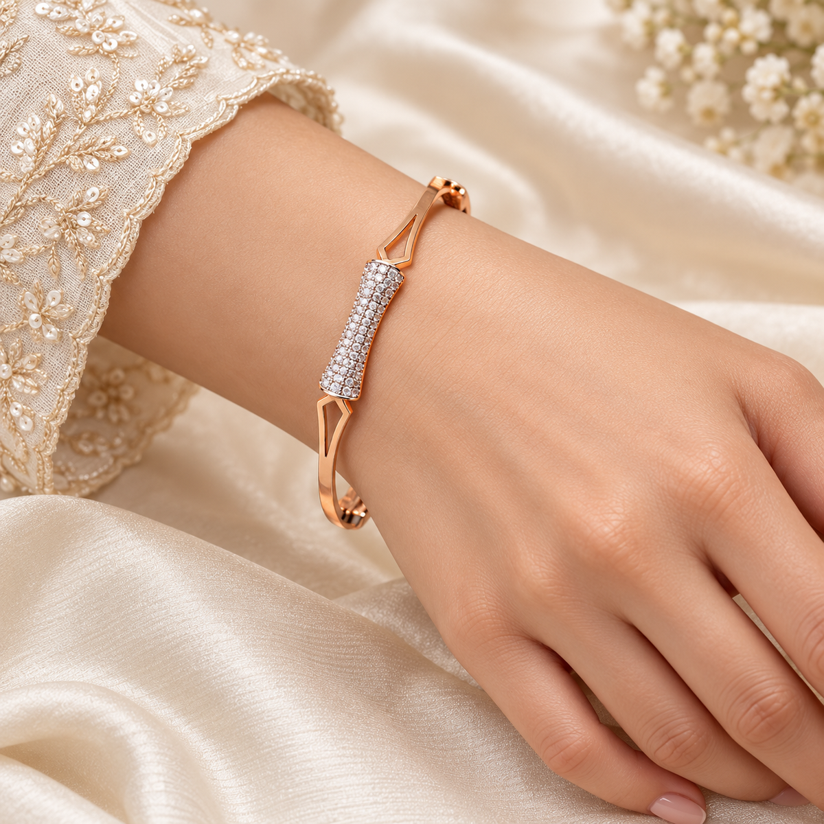 One gold geometric sparkle bangle on model hand
