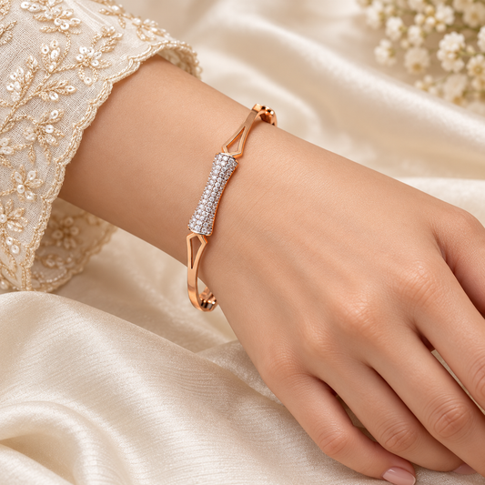 One gold geometric sparkle bangle on model hand