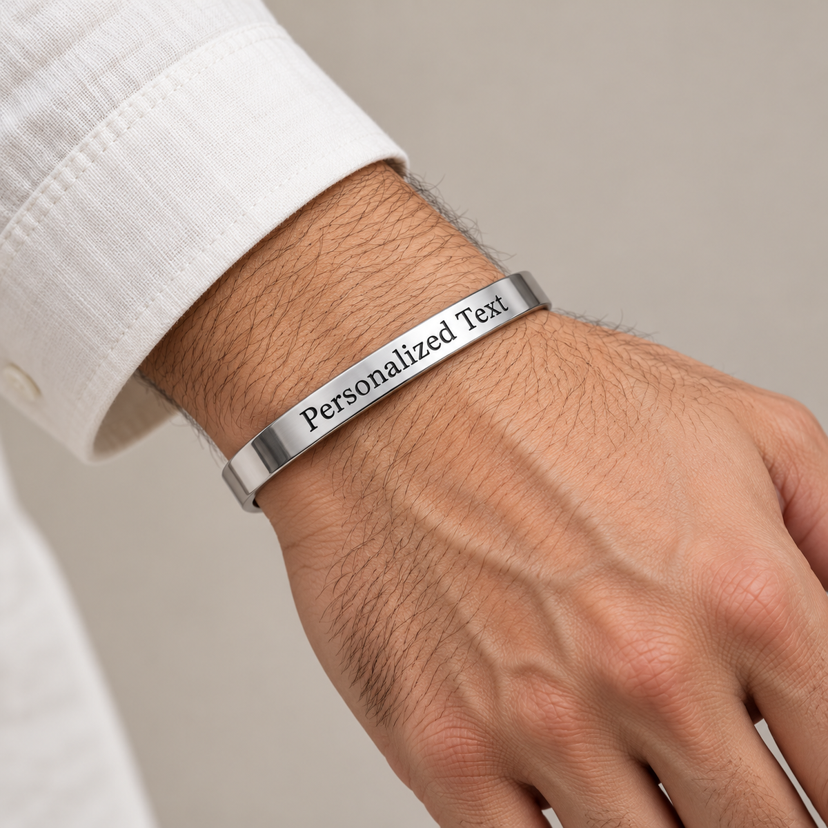 Personalized silver kada on man's wrist