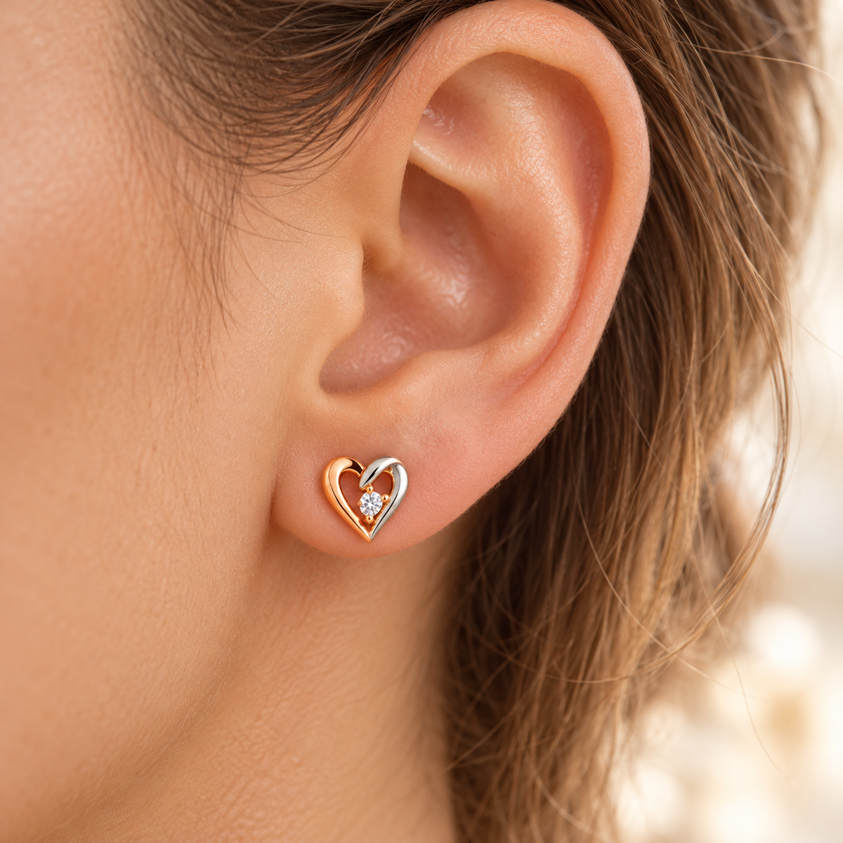 Heart stud earring on model earlobe