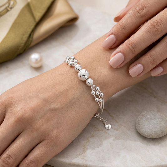 Triple-Strand Silver Beaded Bracelet worn on wrist