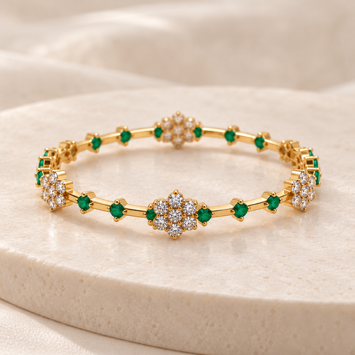 Single Emerald Blossom gold plated bangle on cream stone