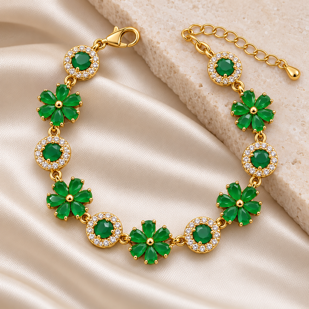 Emerald Flora Halo gold plated bracelet with lobster clasp and adjustable chain on cream satin