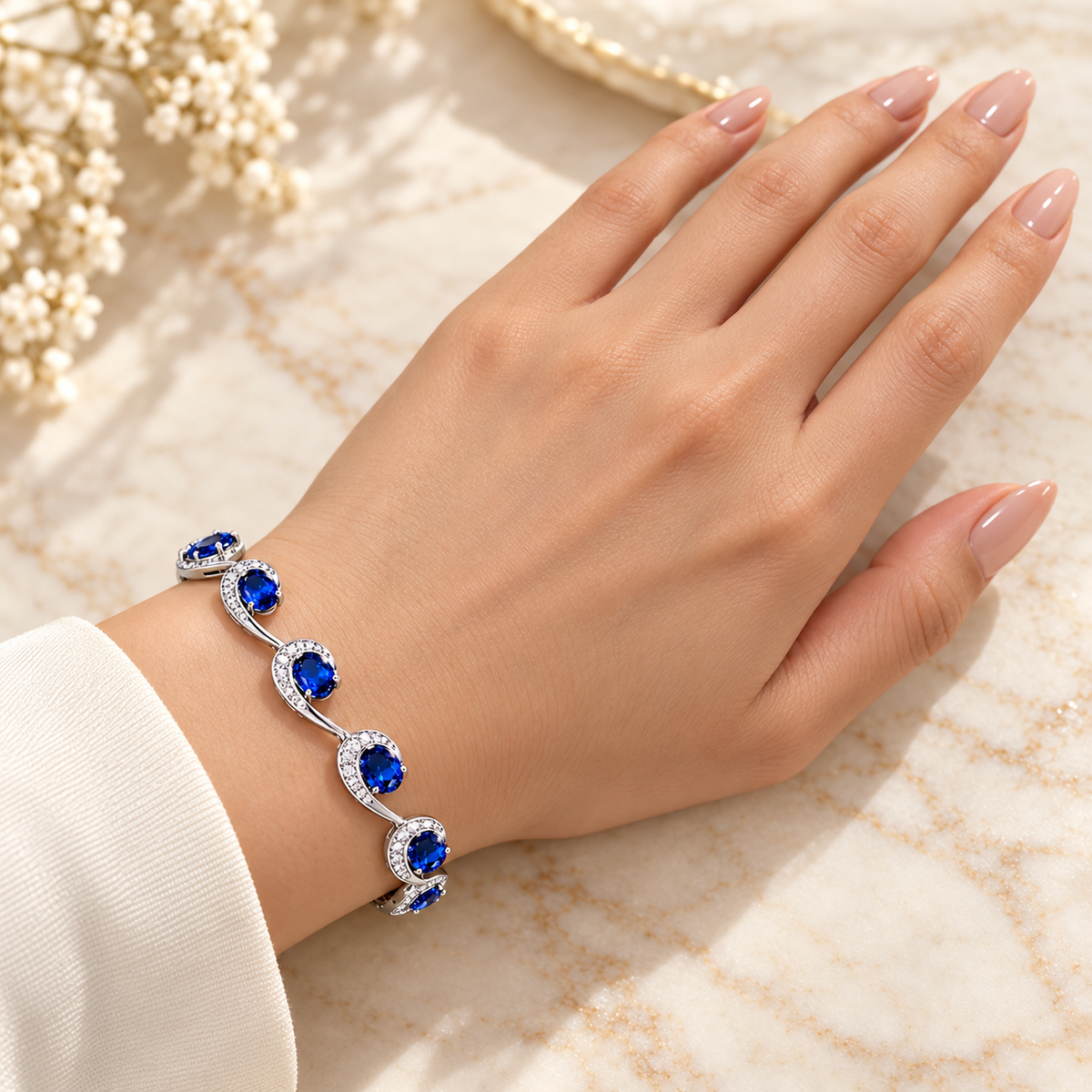 Bracelet original design on full model hand with nude manicured nails
