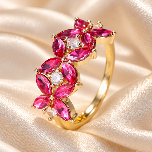 Pink-red floral gold-tone ring on ivory gown fabric