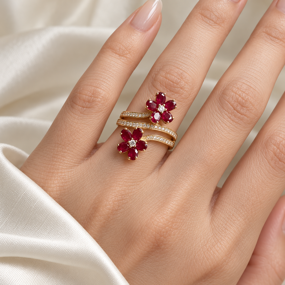 Twin red blossom wrap ring worn on model hand